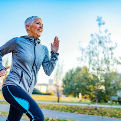 Older Woman Running in Tracksuit