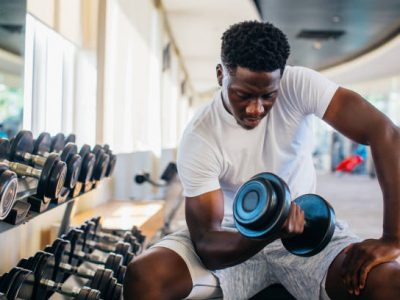 Young Man Exercising with Dumbbell